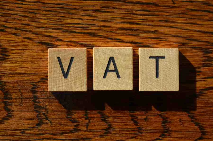 VAT on Commercial Property. Wooden letter blocks spelling VAT on a wood table, representing VAT on Commercial Property