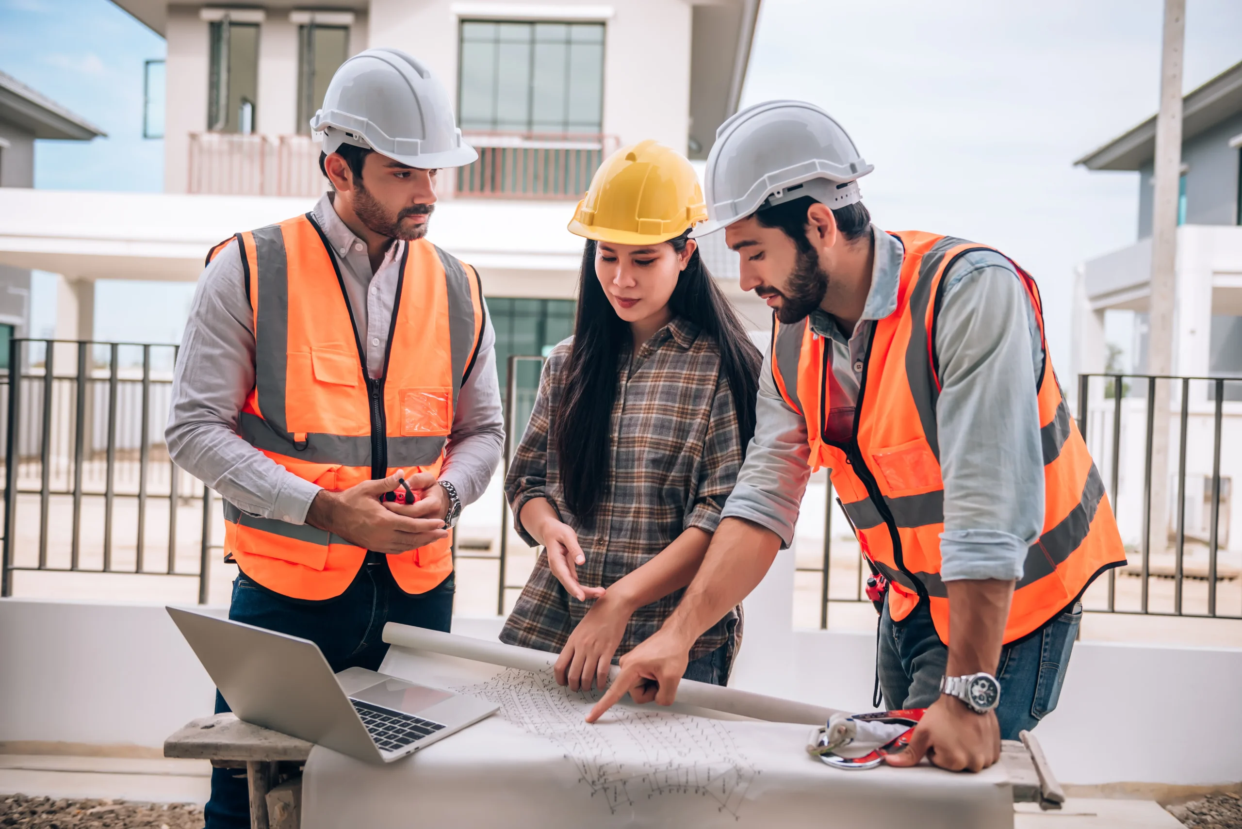 Construction accountants reviewing project plans and bookkeeping records