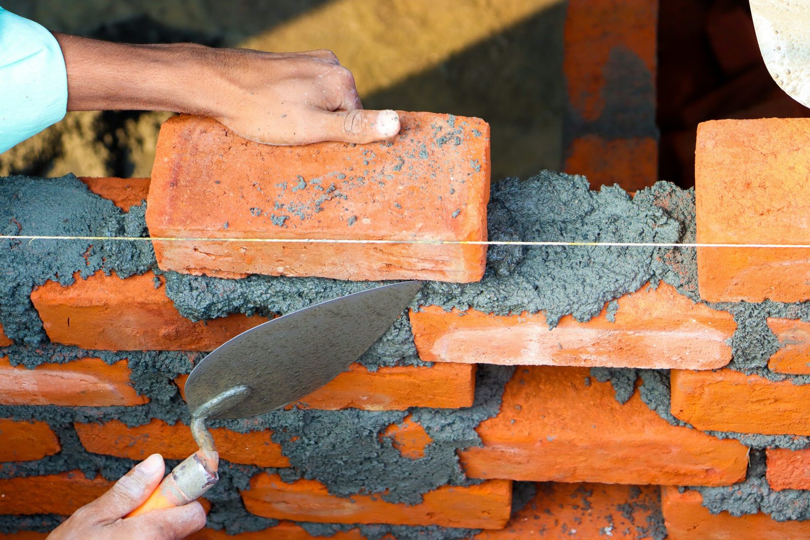 Bricklayer building a brick wall